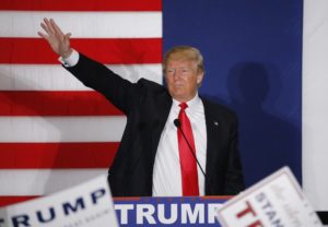 U.S. Republican presidential candidate Donald Trump waves during a campaign rally in Cedar Rapids, Iowa February 1, 2016. REUTERS/Carlos Barria - RTX24ZJD